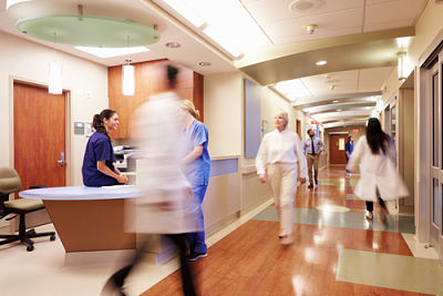 Hospital hallway showing Hospital workers walking in motion