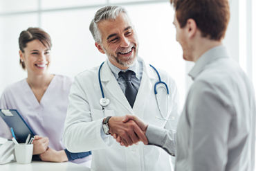 Male Physician is shaking hands with another male
