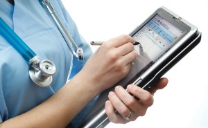 Female Medical Professional writing on a tablet